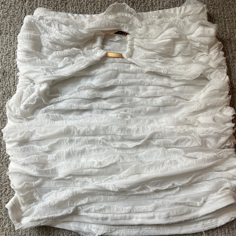 White Ruffled Skirt (or shirt) with gold buckle design.